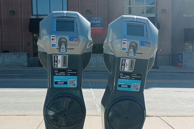 Two ParkSmarter parking meters next to each other in Uptown Normal.